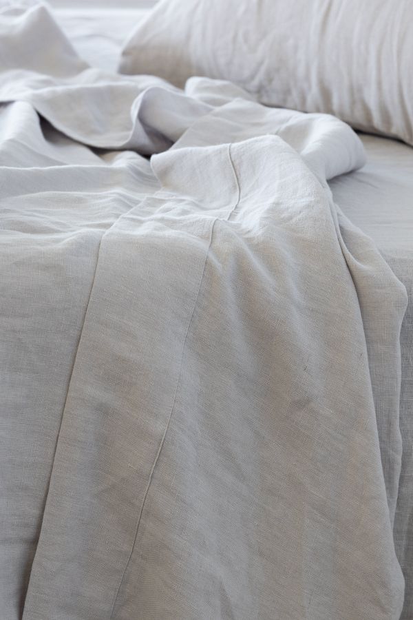100% French flax linen whisper white sheet set on a bed